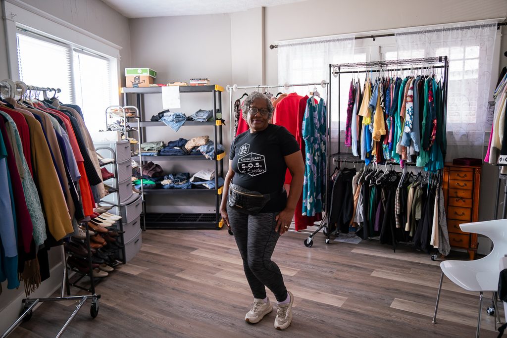 Board Member Henrietta Dean giving a tour of the Clothing Closet